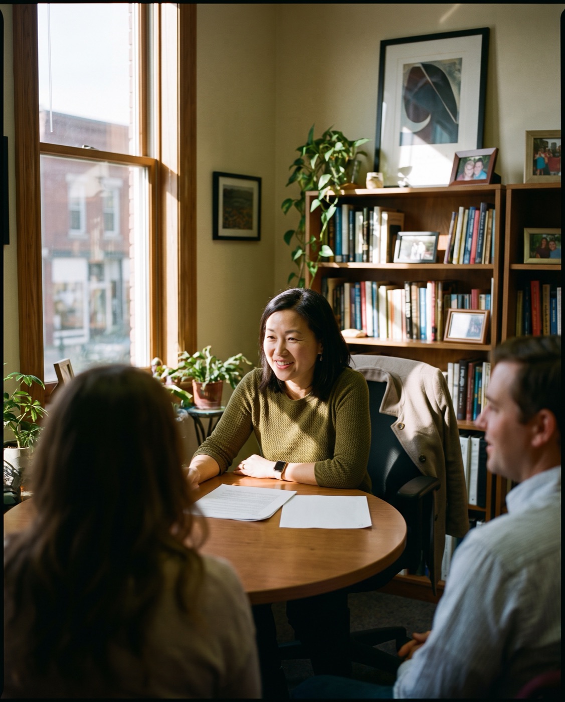A financial advisor meeting with clients in her office.